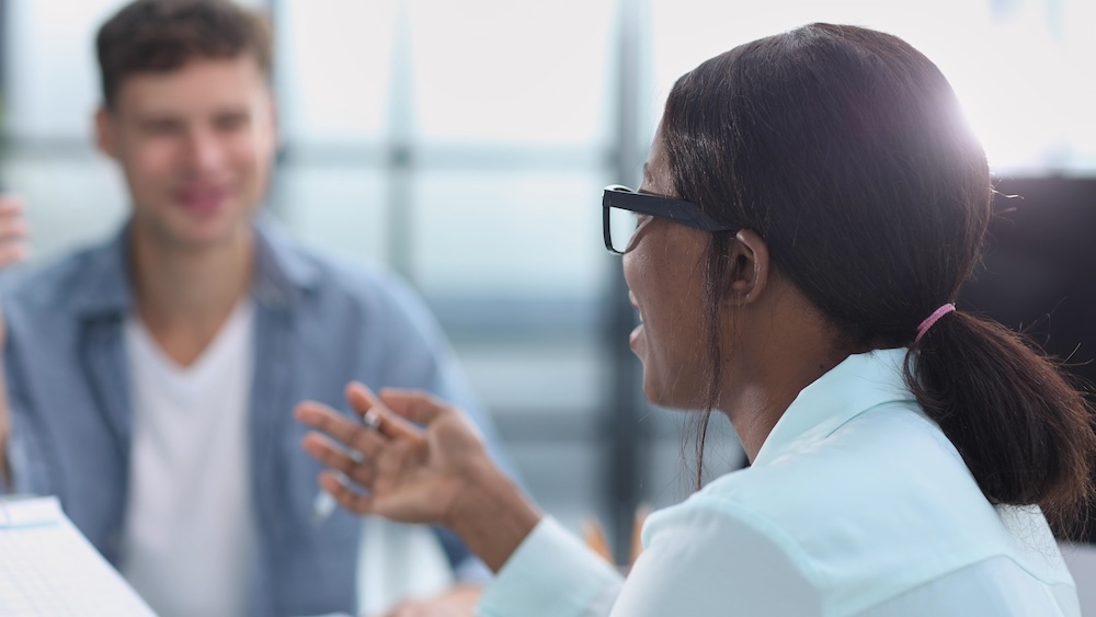 Smiling businesswoman taking interview of a job applicant